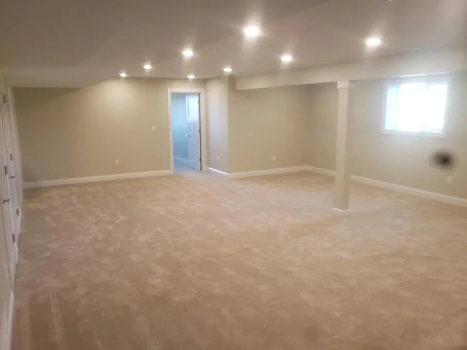 Finished basement with drywall, recessed lighting, and carpet flooring