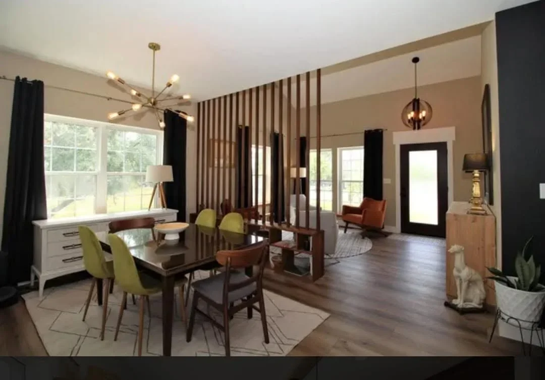 Open concept kitchen with dark wood cabinetry, hardwood floors, and vertical slat room dividers