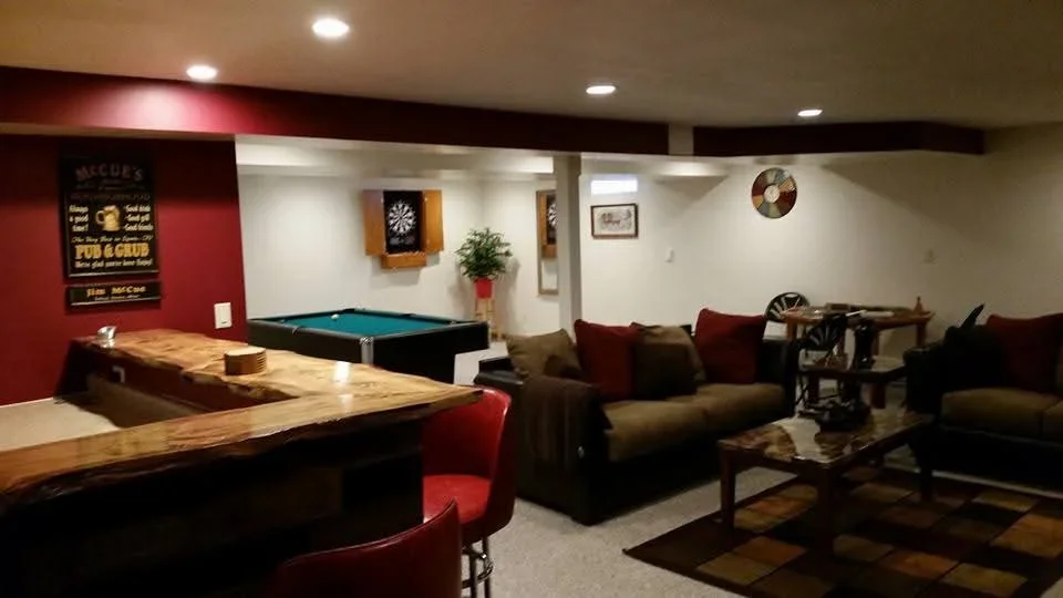 Finished basement with custom wood bar, pool table, lounge seating, and recessed lighting